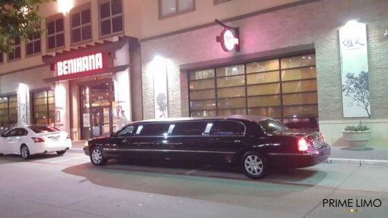 Black Lincoln Town Car stretch limo parked outside Benihana at night