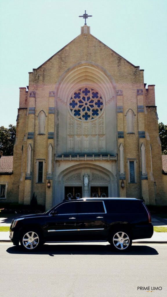 Black Cadillac Escalade in front of Saint Thomas Aquinas Catholic Church