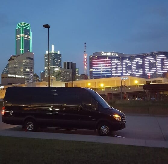 Side of black Sprinter with Omni displaying DCCCD at night
