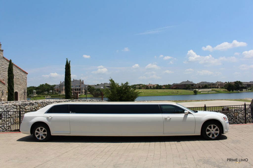 White Chrysler 300 limo in front of a church on a bright sunny day